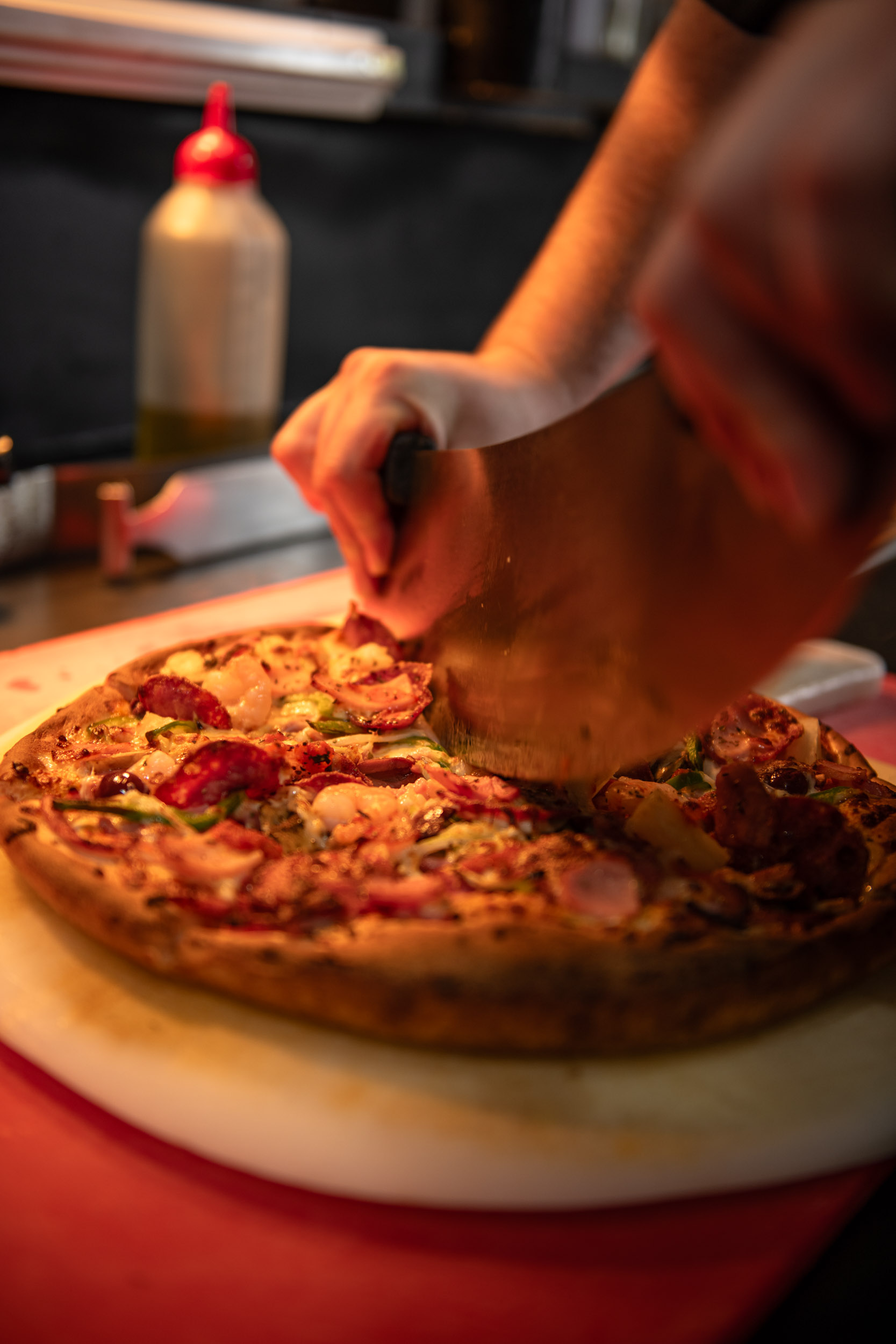 Someone making a pizza.